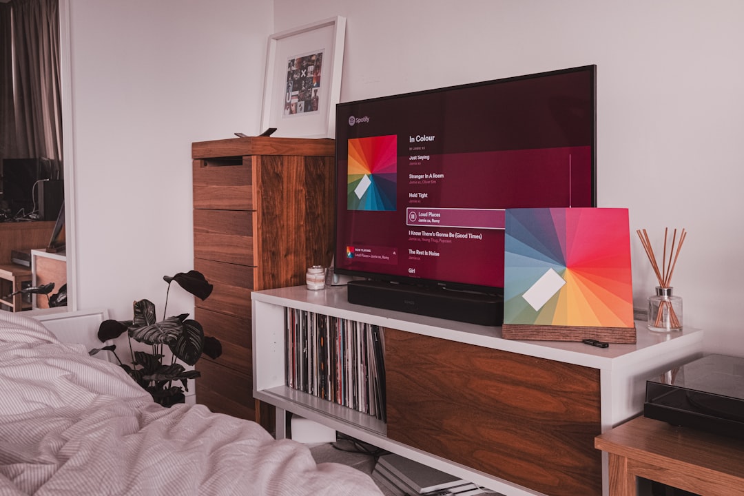 black-flat-screen-tv-on-brown-wooden-tv-rack-sjjhbjhzhas